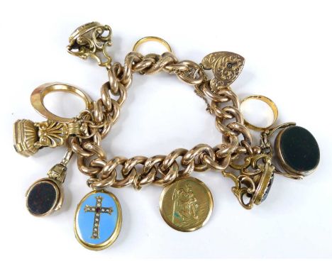 A 9ct yellow gold hollow engraved curb link bracelet with engraved padlock and safety chain and charms attached. A 4.0mm 22ct