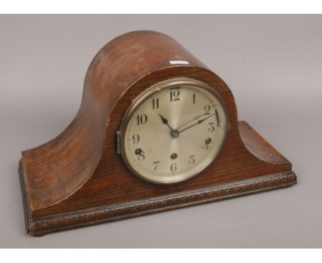A carved oak dome top Westminster / Whitington chime mantle clock, pendulum but no key. 