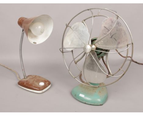 A frost vintage electric fan, along with a vintage desk lamp. 