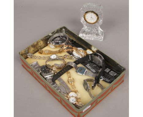 A tin of wristwatches to include manual examples and a Cathedral crystal clock. 