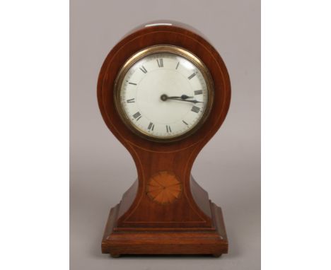 A Victorian inlaid mahogany balloon mantle clock with white enamel dial, raised on four brass feet and with key. 