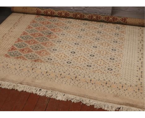 A Persian cream ground wool carpet with central diamond panel decoration, approximately 380cm x 280cm. 