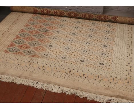 A Persian cream ground wool carpet with central diamond panel decoration, approximately 380cm x 280cm. 