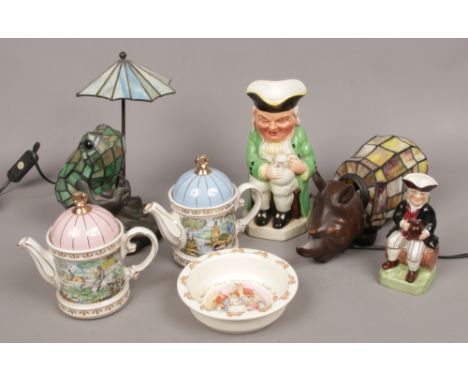 Two Sadler teapots, a Burlington Toby jug, Bunnykins dish, along with a illuminating frog lamp and similar rhino lamp. 