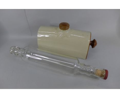 A mid 20th Century Pyrex glass rolling pin and a stoneware bed warmer 