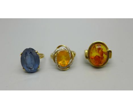 Three gold rings, a 9ct gold, citrine and diamond ring, 3.6g, R, a 9ct gold and amber ring, 5.9g, Q and a 9ct gold and blue s