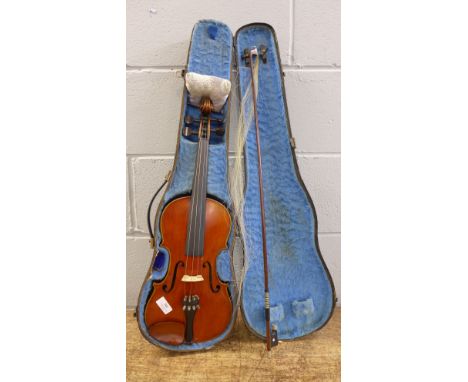 An Italian violin marked Imperial Violin Guarnerius, cased with bow, circa 1900, length of back 35cm excluding button 