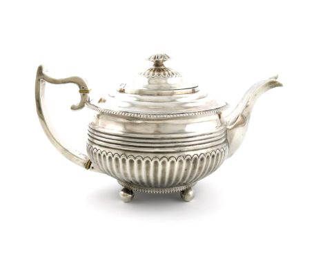 λA George III silver teapot, by Solomon Hougham, London 1816, circular form, part-fluted decoration, gadroon border, the scro