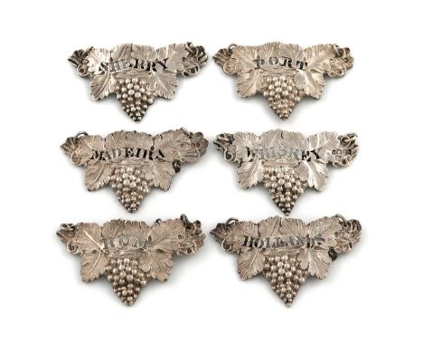 A set of six Victorian cast silver wine labels, by William Eaton, London 1839, vine leaf form with a bunch of grapes, pierced