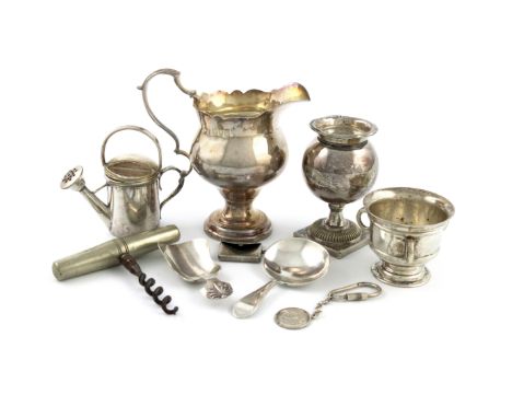 A mixed lot, comprising silver items: a cream jug, London 1905, a caddy spoon with bright-cut borders, Sheffield 1877, a stam