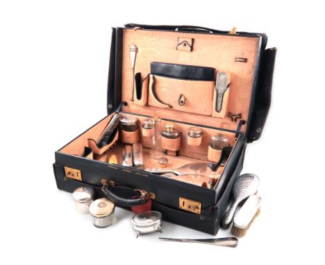 λA silver-gilt travelling dressing table set, by Finnigans Limited, London 1927, with engine-turned decoration, initialled ,c