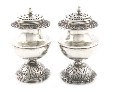 A pair of 19th century silver pepper pots, unmarked, probably Chinese or Indian, circa 1840, circular bellied form, chased fo