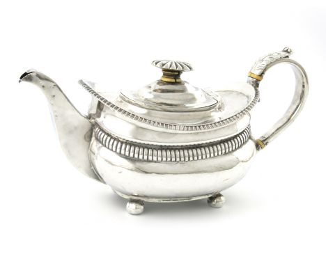 λA George IV silver teapot, maker's mark worn, London 1827, oblong bellied form, fluted girdle, leaf capped scroll handle wit