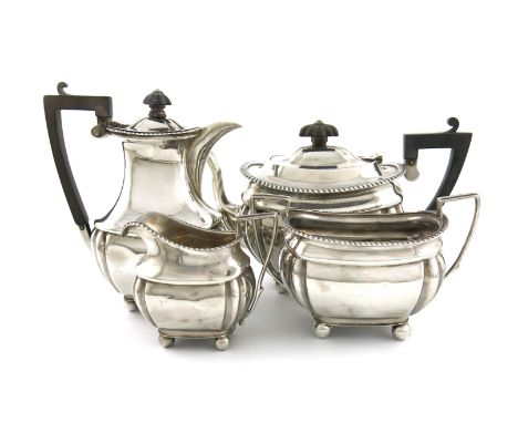 A four-piece Edwardian silver tea set, by Robert Pringle, London 1908 /1909, rounded rectangular form, scroll handles, gadroo