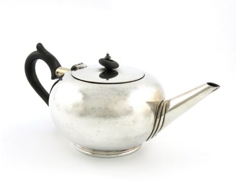 A silver teapot, by William Hutton and Sons, Sheffield 1937, compressed circular bullet form, tapering spout, scroll handle, 