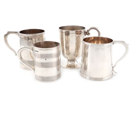 A small collection of four silver mugs, comprising: a Victorian mug, of plain vase form, on a raised circular foot, with a sc