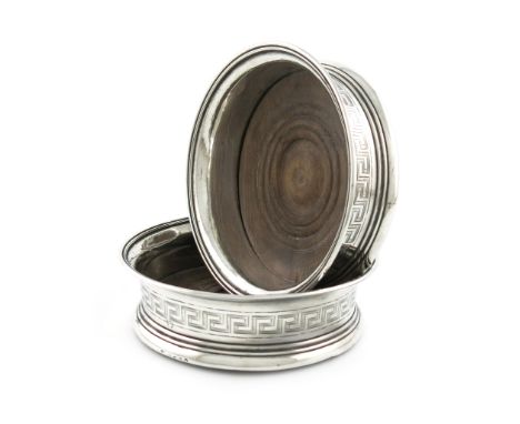 A pair of George III silver wine coasters, by John Emes, London 1805, circular form, with an engraved Greek Key border, turne