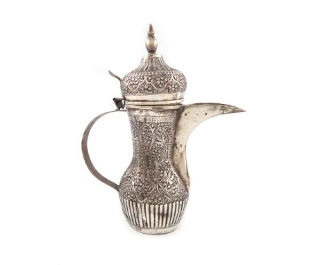 An Egyptian silver coffee jug, of baluster form, elongated spout, scroll handle, chased decoration, the hinge damaged, the co