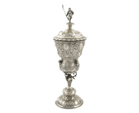 A 19th century German silver standing cup and cover, tapering baluster form, embossed decoration, the finial of the pull-off 