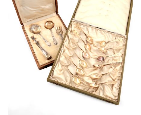 A late 19th century French parcel-gilt silver serving set, comprising: a pair of sugar tongs, a sifting spoon, a serving fork