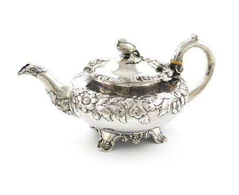 λA Victorian silver teapot, by J and J Angell, London 1839, circular form, embossed foliate decoration, scroll handle with iv