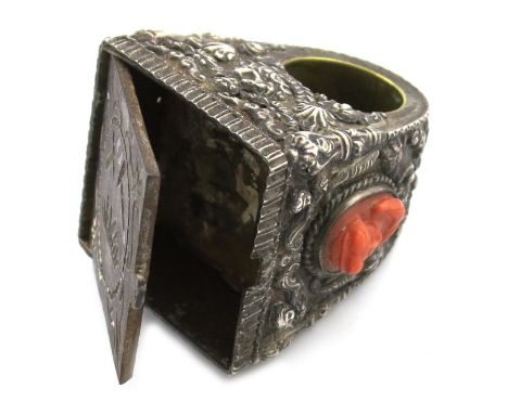 λA large 19th century cased silver ring, unmarked, chased with medallions and foliate decoration and set with an oval coral c