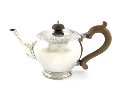 A silver teapot, possibly by T Rawlings, London 1936, bullet form, wooden scroll handle and finial, flush hinged cover, chase