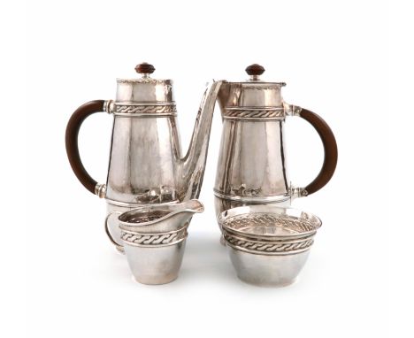 By Liberty and Co and W. Haseler, a matched four-piece Arts and Crafts silver coffee set, Birmingham 1911,1912, 1916 and 1920