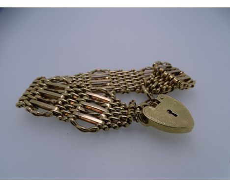 SEVEN BAR 9CT GOLD GATE BRACELET with safety chain and bright cut padlock, 34.5grms