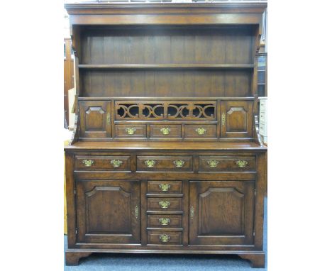QUALITY REPRODUCTION OAK WELSH DRESSER having a canopy type two shelf rack with hanging hooks over a drop down fretwork front