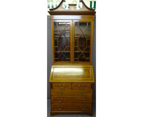 EXCELLENT CROSSBANDED MAHOGANY BUREAU BOOKCASE, circa 1900 with broken swan neck pediment and Sheraton style fan over twin th