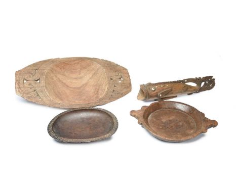 A Massim bowlTrobriand Islands, Papua New Guineawith carved and pierced ends,64.5cm long,a Massim bowl with a carved ovolo bo