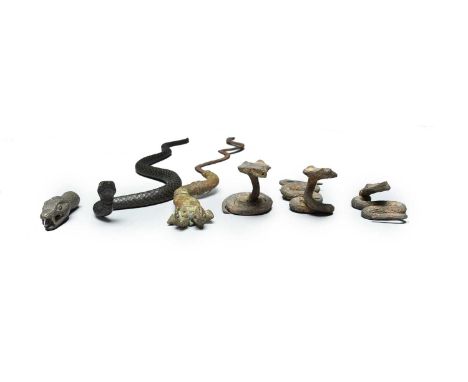 A cast bronze model snake with inset shell eyes,39cm long,three West African iron model snakes, a wavy iron blade with a bras