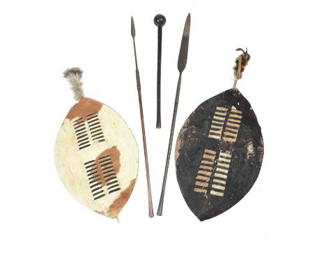 Two Zulu shields South Africahide, wood and fur,101cm long, two Zulu spears, one with fine brass wire binding with an ebonise