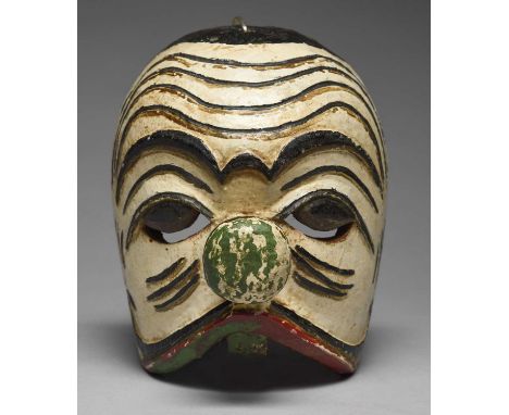 A Bali maskIndonesiawith carved and painted decoration and an applied button nose, 19cm high.