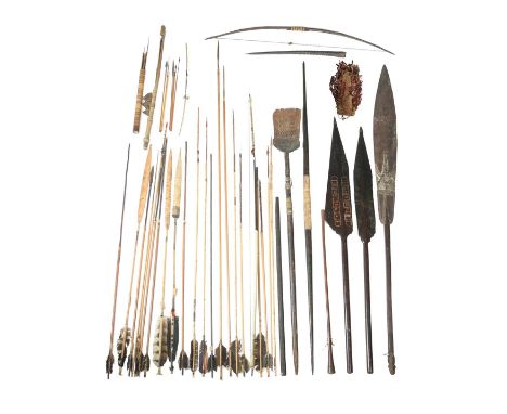 Two Amazon bowspalmwood with fibre binding,179cm and 205cm long, twenty one Amazon bamboo arrows, with feather flights and wo