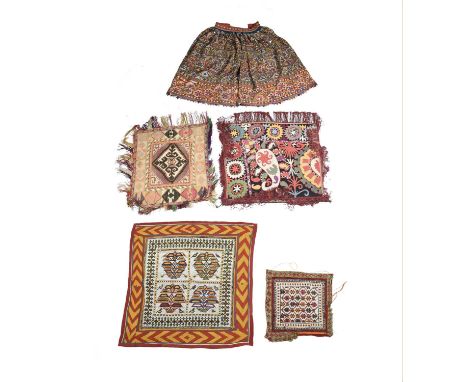 An Indian Banjara skirtembroidered with circular mirror panels,87cm high, an Uzbek ceremonial embroidered panel, an Uzbek / T
