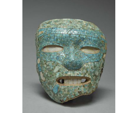 An Aztec / Mixtec style maskearthenware with fine turquoise, greenstone and shell mosaic decoration, 17cm high.
