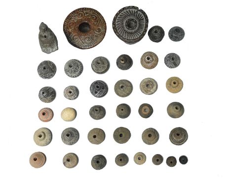 A collection of spindle whorlsthe majority pottery with circle, dot and linear decoration, probably Central America, one with
