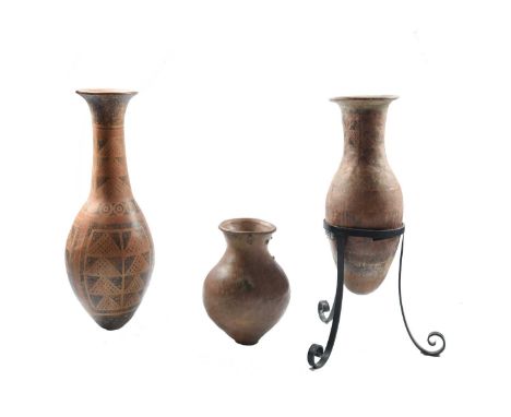 Two Narino long necked vesselsColombiapottery, with polychrome geometric decoration,73cm and 56cm, one in a tripod stand, and