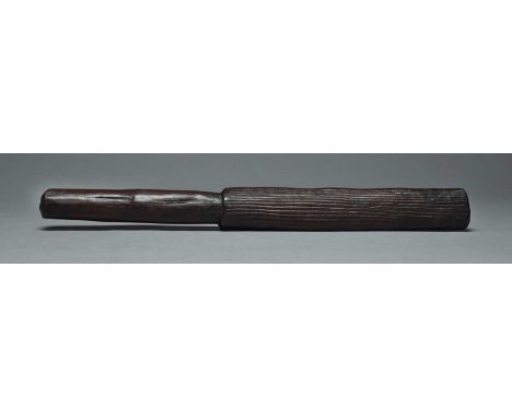 A Fiji tapa beaterMelanesiaof elliptical form with carved grooves and with a cylindrical handle,37cm long.