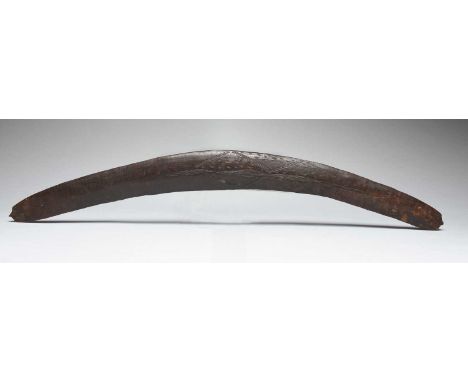 An Aboriginal boomerangQueensland, Australiawith linear and dash incised decoration and with carved pointed ends,67cm wide.