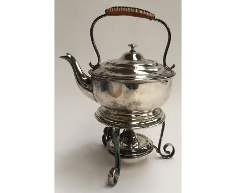 An early 20th century silver plate teapot with wicker handle on stand with burner, made by Thomas White & Co., Birmingham.Mon