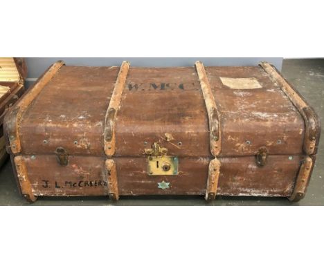 A vintage travel trunk with wood and metal bracing, the top monogrammed W. McC. 