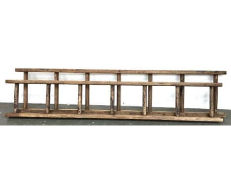 A vintage two piece wooden ladder 