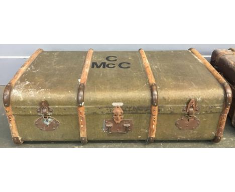 A vintage travel trunk made by Au Lézard, with wood and metal bracings, the top monogrammed C McC 