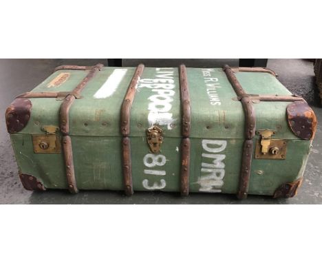 A vintage travel trunk with wood and metal bracing, 'Miss E Williams' to top, together with a number of bound National Geogra