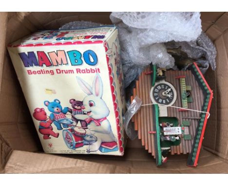 A boxed Mambo beating drum rabbit, together with a Swiss cuckoo clock, brass bookends, and a set of old keys 