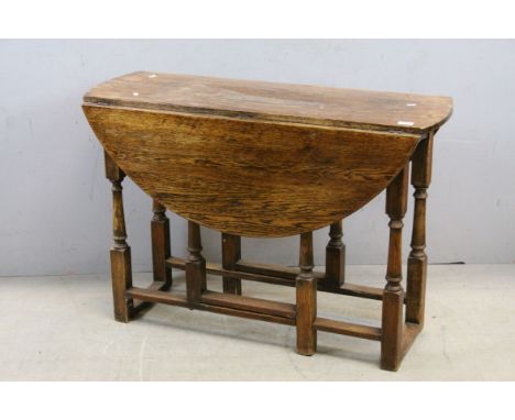Oak Gate-leg Table raised on Turned Baluster and Block Supports, 107cms wide x 73cms high