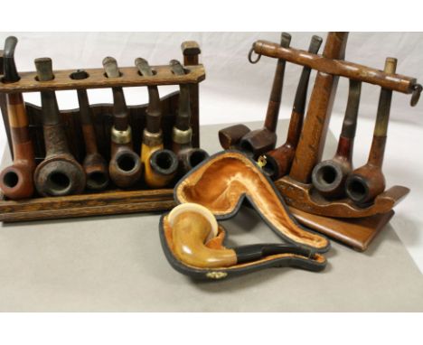 Two wooden pipe racks, one modelled as an anchor, plus a collection of pipes to include Peterson &amp; Meerschaum 